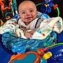baby, blanket, blue, child, clothing, face, happy, indoor, octopus_toy, play_center, plastic_toy, smile, star_mirror, toy, toddler, wrapped, infant, seat, colorful, hands