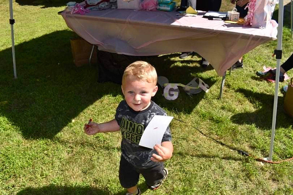 Kaden is registered to the contest to win money with this photo: baby, chair, event, fun, garden, grass, green, joy, lawn, leaf, leisure, outdoor_furniture, person, plant, recreation, shorts, soil, summer, t_shirt, table