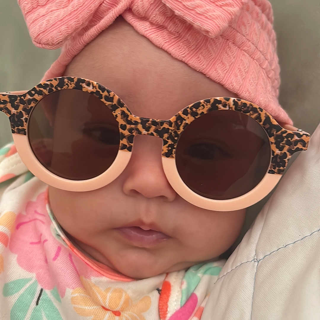 Mía joined the competition — help win amazing prizes! accessories, baby, beanie, bonnet, cap, clothing, face, glasses, happy, hat, head, newborn, person, photography, portrait, purple, smile, sunglasses, sunhat, turban