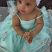 Milani is registered to the contest to win money with this photo: toddler, child, dress, headband, flower, outdoor, sandals, hands, embroidery, stone, pavement, skin, face, eyes, sitting, cute, fashion, summer, nature, portrait