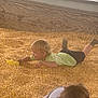 Thomas Brock joined the competition — help win amazing prizes! child, children, corn, corn_kernels, indoor, play, toy, yellow, green_shirt, black_shorts, blond_hair, brown_hair, floor, window, wood, fun, crawling, lying, play_area, happy