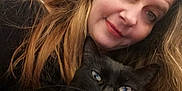 Lolita a rejoint le concours — aidez-le/la à gagner de superbes lots ! woman, cat, black_cat, indoor, selfie, long_hair, hand, shelf, bottle, face, pet, holding, portrait, casual, expression, home, animal, cute, feline, closeup
