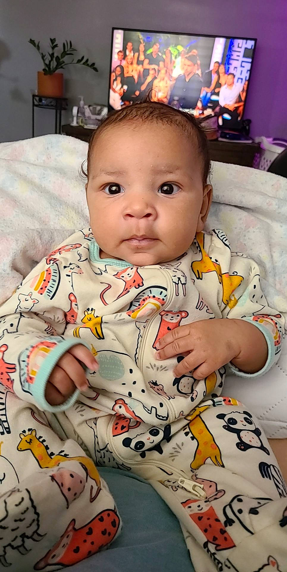 Faye is registered to the contest to win money with this photo: baby, baby_toddler_clothing, blurred, cheek, child, comfort, facial_expression, hairstyle, happy, human, linens, mouth, nose, people, person, product, skin, sleeve, t_shirt, television