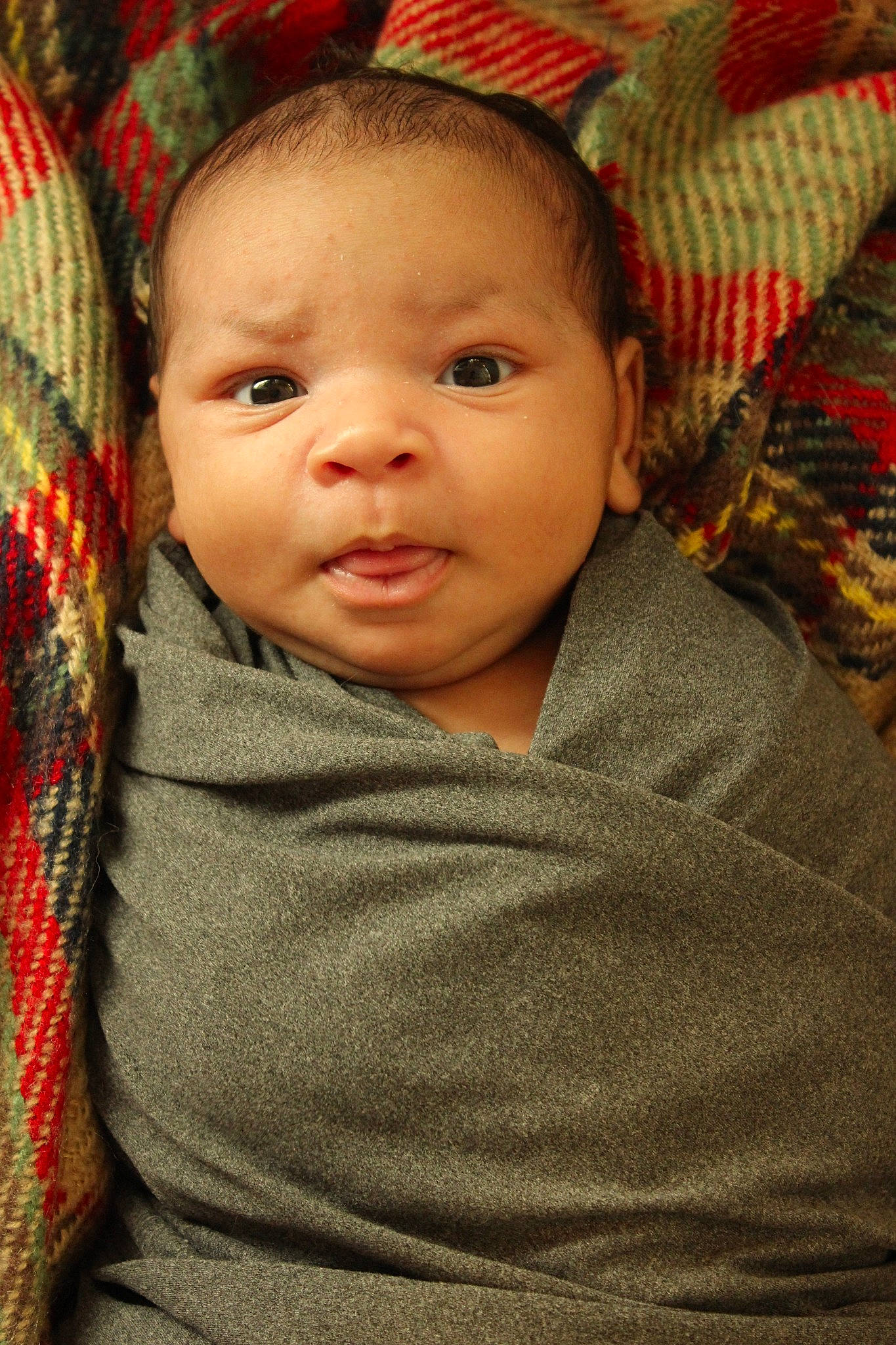 Faye is registered to the contest to win money with this photo: baby, baby_toddler_clothing, cheek, child, chin, comfort, eye, face, facial_expression, forehead, iris, lip, nose, person, plaid, skin, sleeve, smile, tartan, toddler