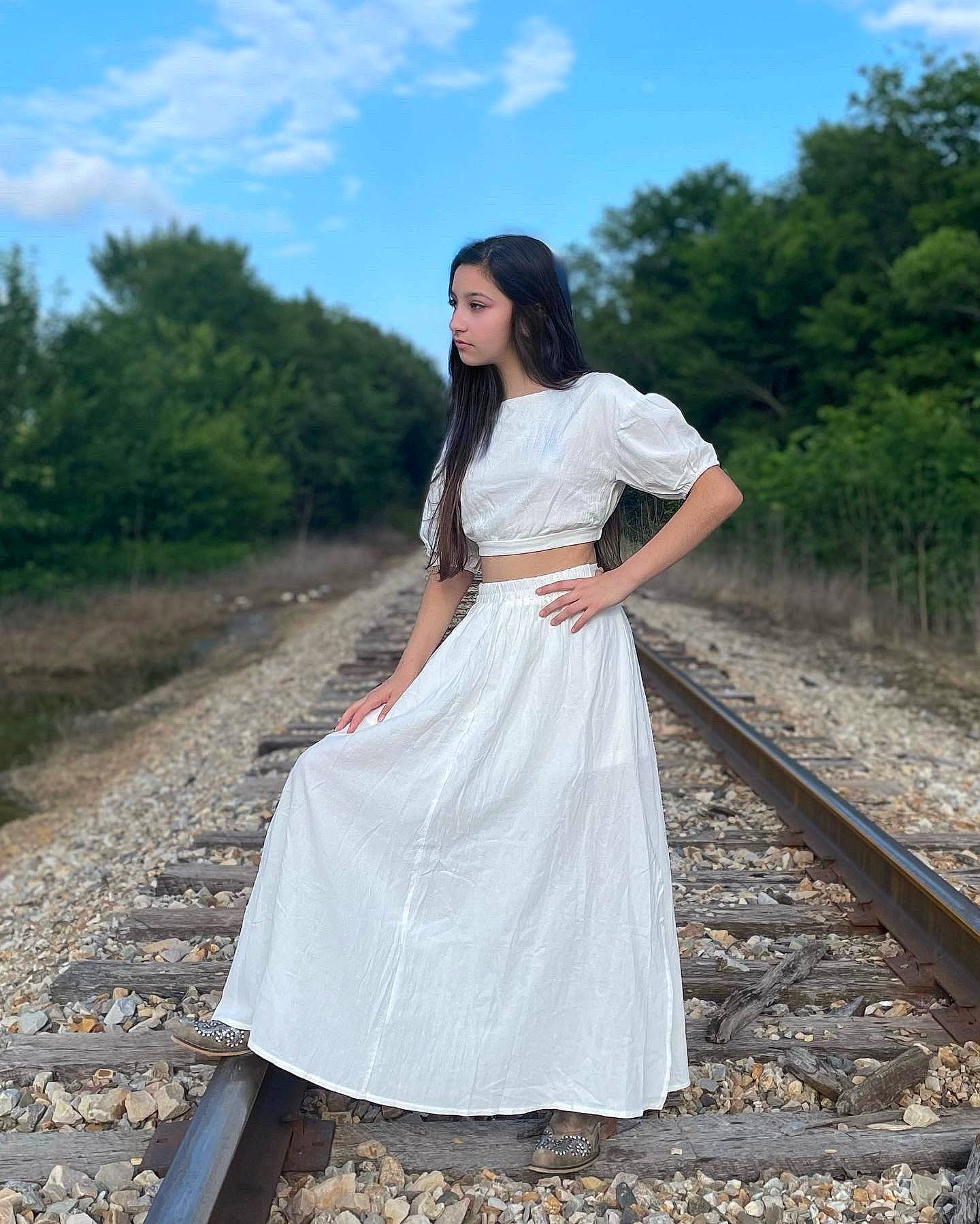 Audriana is registered to the contest to win money with this photo: cloud, dress, fashion_design, flash_photography, gown, grass, hair, happy, human_body, leg, one_piece_garment, people_in_nature, person, plant, shoulder, sky, sleeve, track, tree, waist