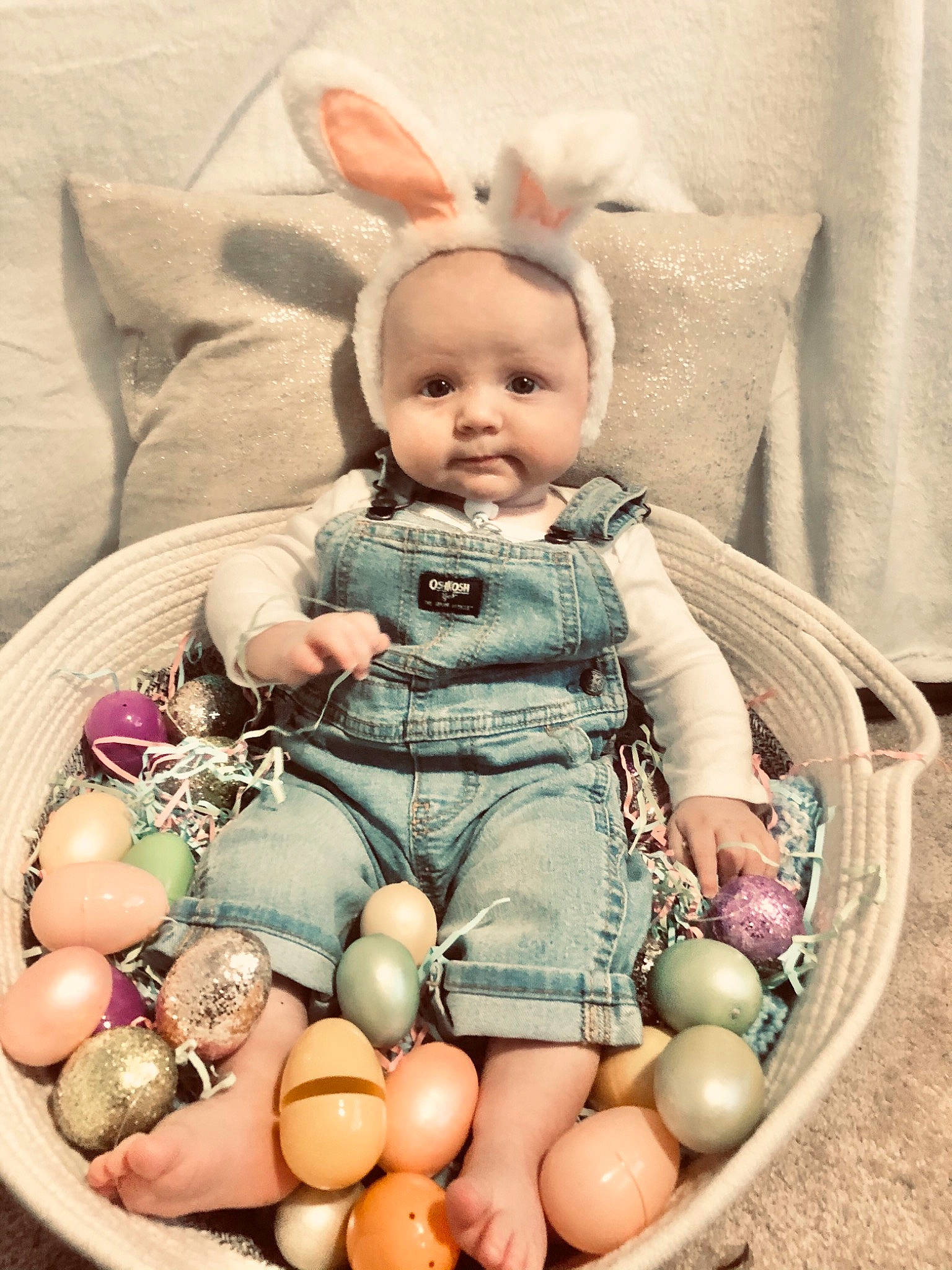 Landon is registered to the contest to win money with this photo: baby, baby_toddler_clothing, basket, cheek, child, collectable, doll, dress, easter, event, grass, happy, person, pink, sitting, skin, stuffed_toy, sweetness, textile, toy