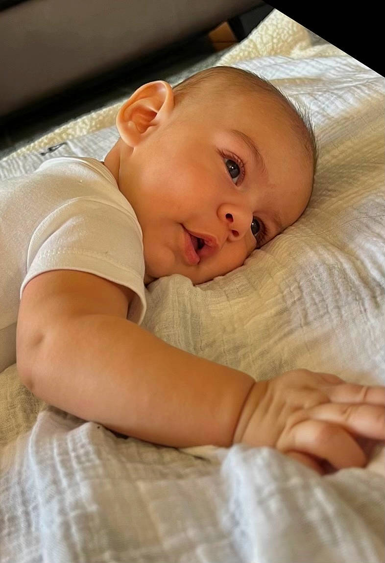 Alessandro Cristiano is registered to the contest to win money with this photo: baby, baby_products, baby_safety, baby_toddler_clothing, bedding, bedtime, child, comfort, eyebrow, flooring, iris, linens, person, portrait_photography, room, sitting, skin, sleep, sleeve, smile