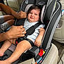 baby, child, car_seat, car_interior, harness, straps, person, hands, seat_belt, grumpy_face, infant, clothing, car, safety, seat, transportation, adjusting, expression, cute, indoors