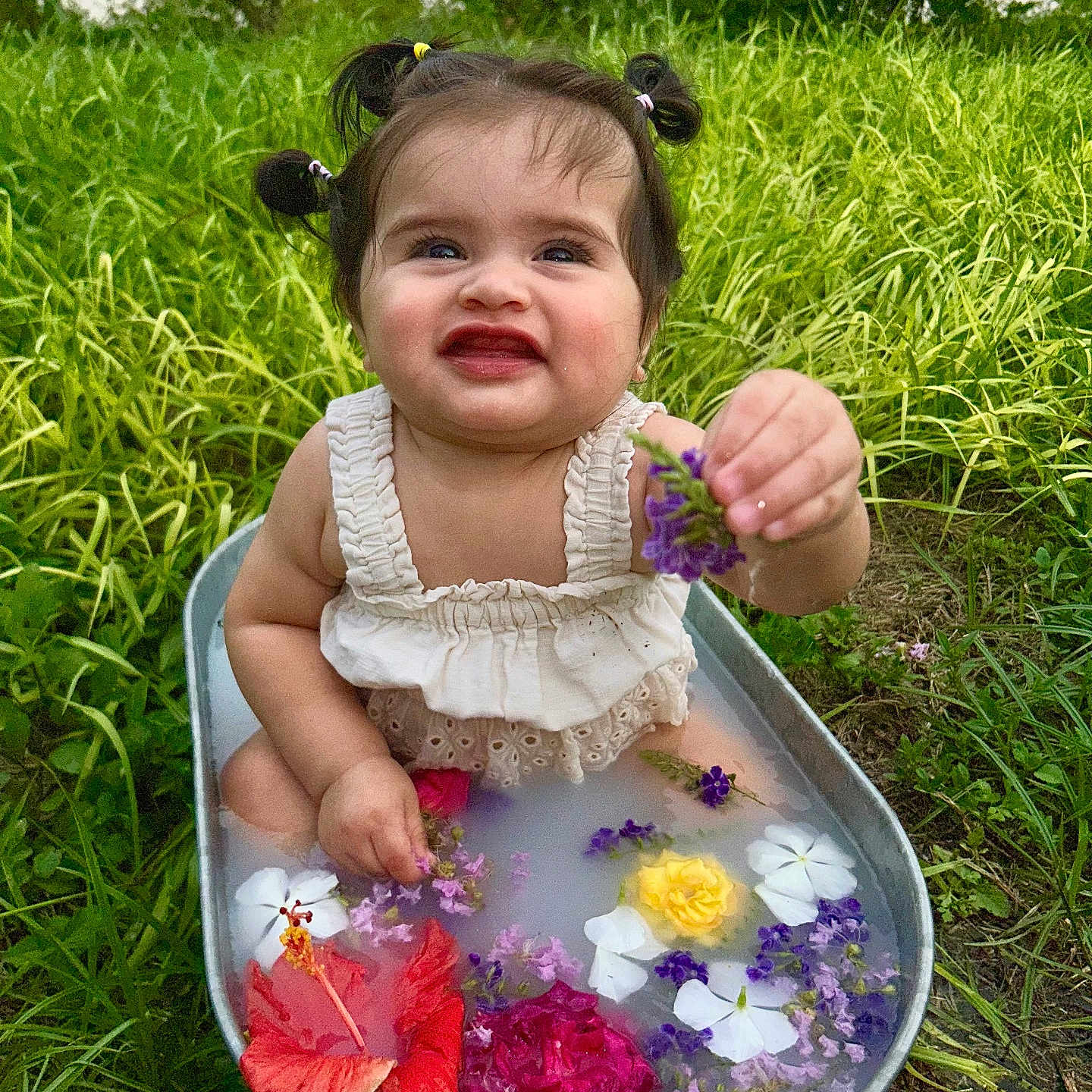 Jhaylani joined the competition — help win amazing prizes! baby, child, colorful, cute, flower, flowers, garden, grass, greenery, metal_tub, milky_water, nature, outdoor, pigtails, playful, sitting, smiling, summer, water, white_dress