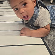 Rowan joined the competition — help win amazing prizes! baby, carpet, child, clothing, curly_hair, cute, denim, drool, expression, eyes, face, floor, hand, head, indoor, mouth, person, striped_mat, surprised, toddler