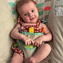 baby, infant, smiling, sitting, romper, baby_seat, colorful, monkey_design, toy, playful, cute, child, happy, indoors, patterned_fabric, person, young_child, comfort, expression, skin