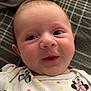 Oaklee is registered to the contest to win money with this photo: baby, infant, face, smile, clothing, minnie_mouse, polka_dots, pink_bow, cute, lying_down, blanket, plaid, happy, expression, child, young, portrait, indoors, cozy, apparel