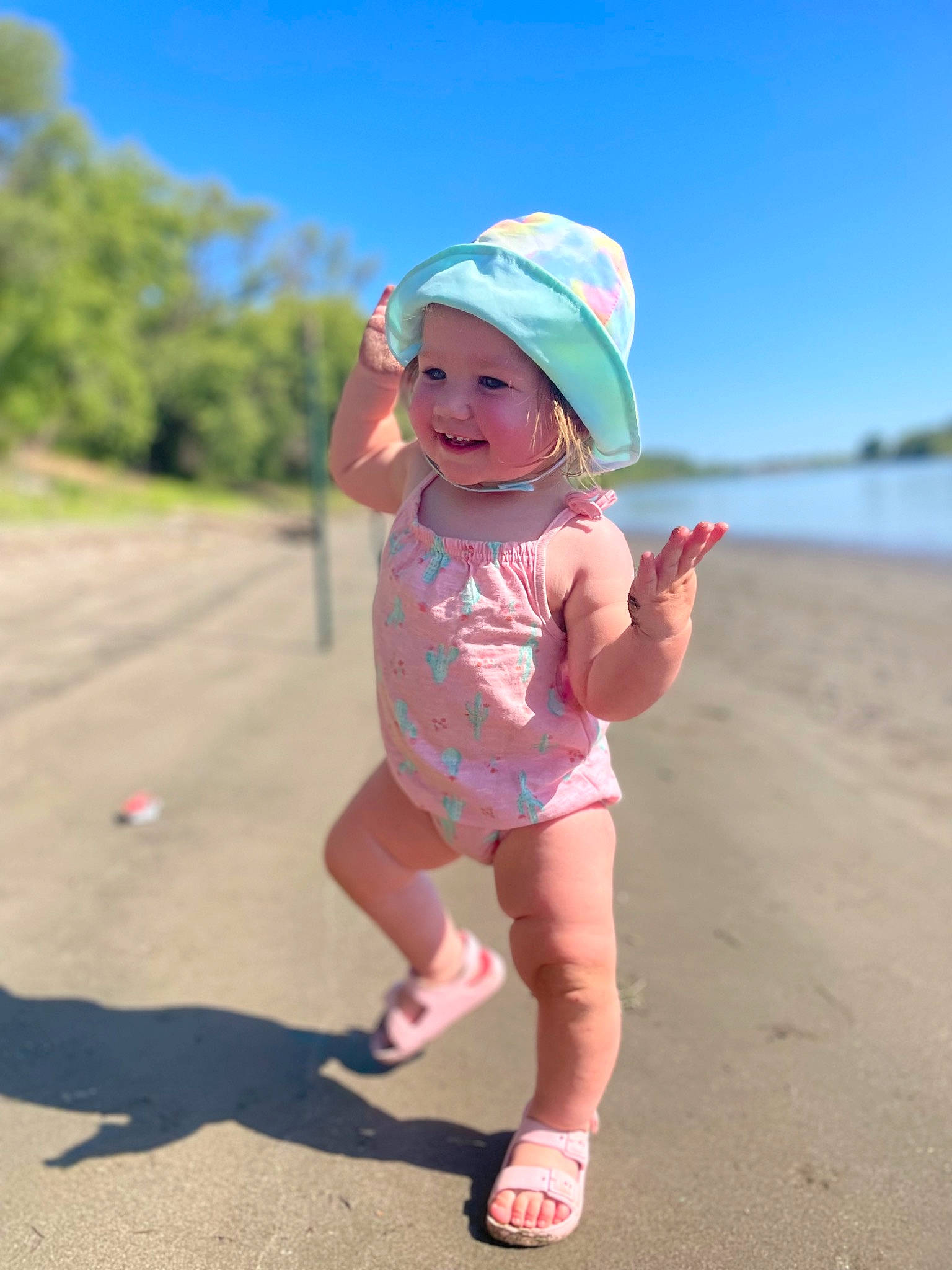 Haylee is registered to the contest to win money with this photo: baby, baby_toddler_clothing, baseball_cap, beach, body_of_water, eyewear, fun, happy, hat, head, headwear, joy, leisure, natural_environment, person, pink, recreation, sky, sun_hat, sunlight