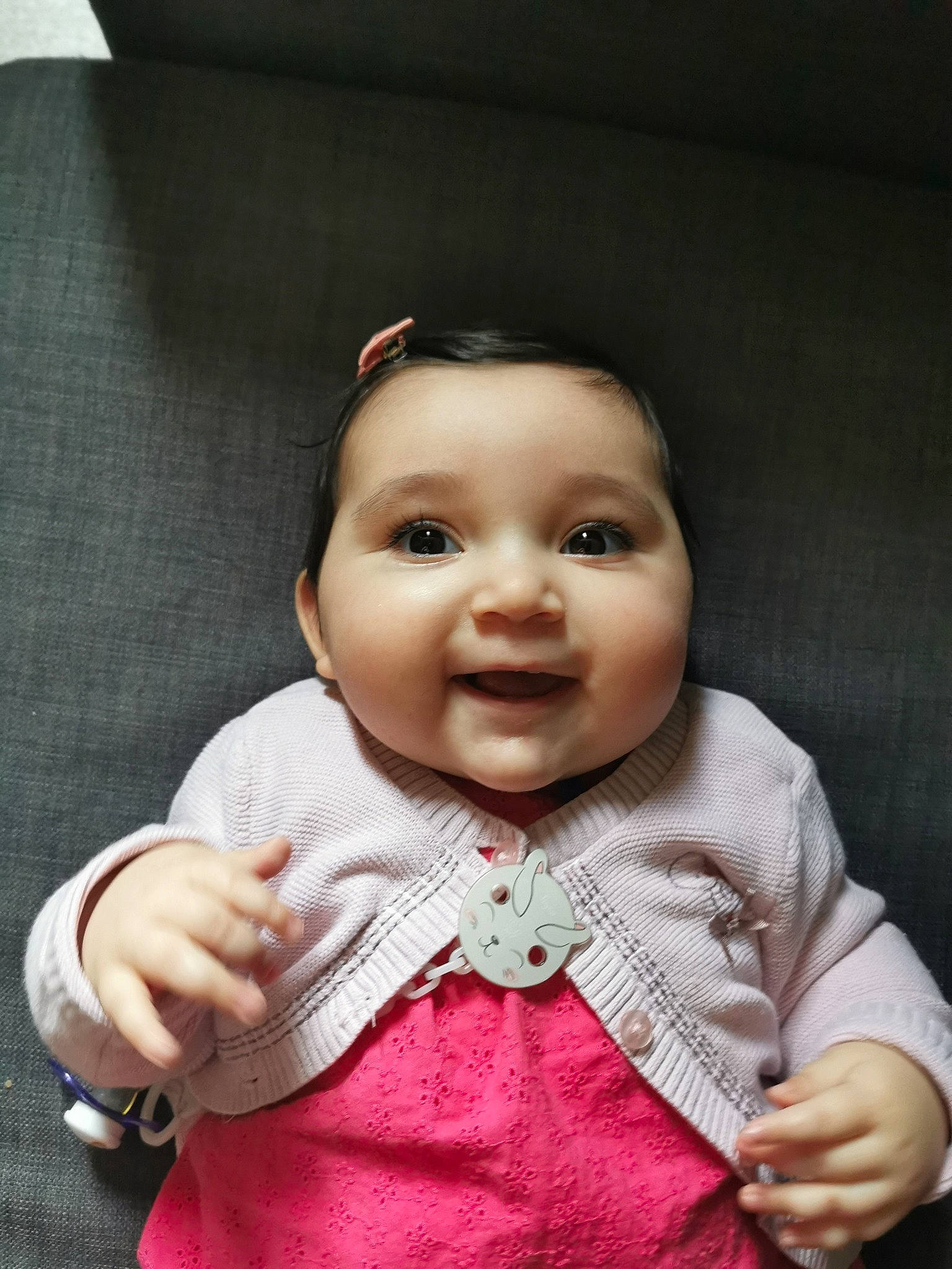 Neïssa participe au concours pour gagner de l'argent avec cette photo : baby, baby_toddler_clothing, cheek, chin, collar, dress, eyelash, flash_photography, gesture, hair, happy, head, headwear, iris, lip, nose, outerwear, person, pink, skin