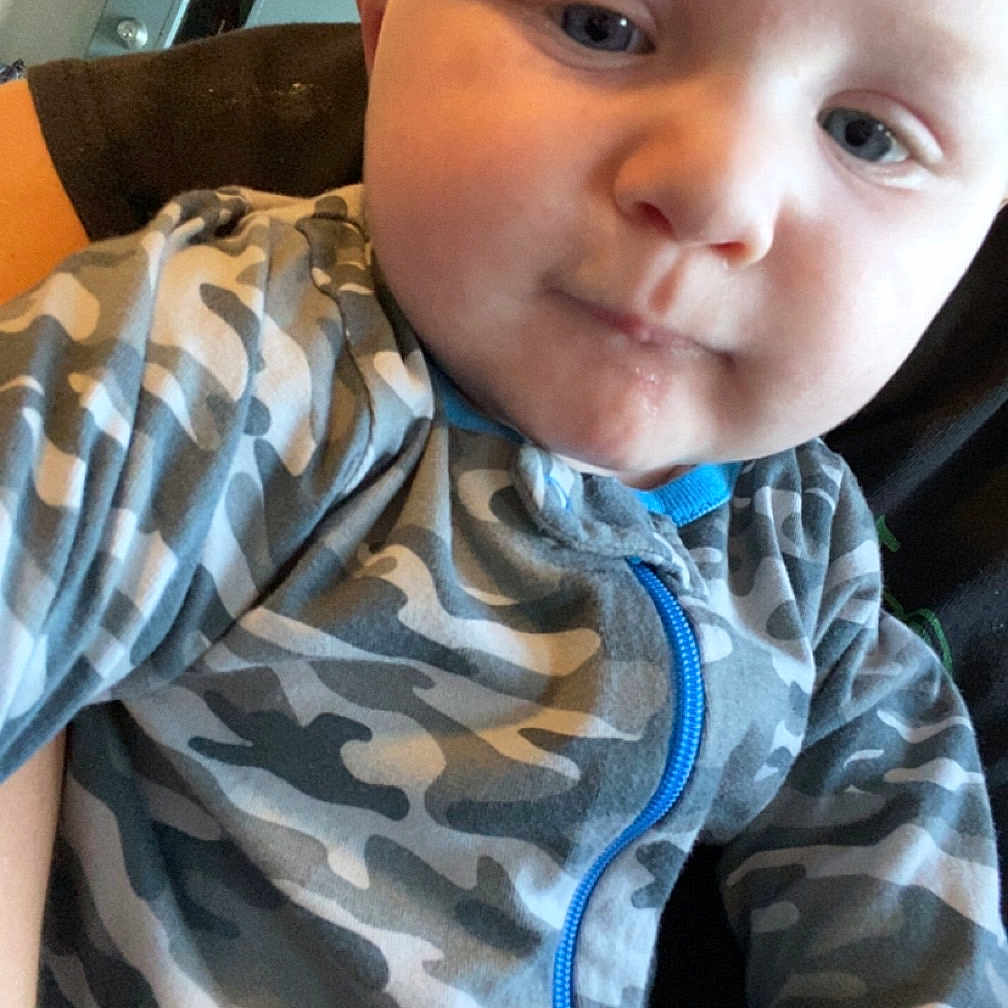 Jaxson is registered to the contest to win money with this photo: baby, clothing, coat, crawling, face, fleece, head, hoodie, jacket, knitwear, military, pants, person, photography, portrait, selfie, shirt, sweater, sweatshirt, t_shirt