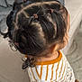 back_view, brown_hair, casual, child, couch, cozy, cute, earring, hair, hairbands, hairstyle, indoors, orange_stripes, person, ponytails, soft_fabric, striped_clothing, toddler, white_clothing, young_child