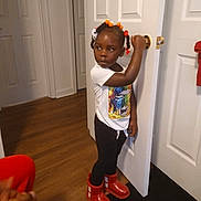 Allison joined the competition — help win amazing prizes! casual_clothing, child, curious, door, girl, hair_beads, hand_on_door, home, indoors, memory, portrait, red_boots, room, screen, smartphone_screenshot, social_media, standing, white_tshirt, wood_floor, young_child