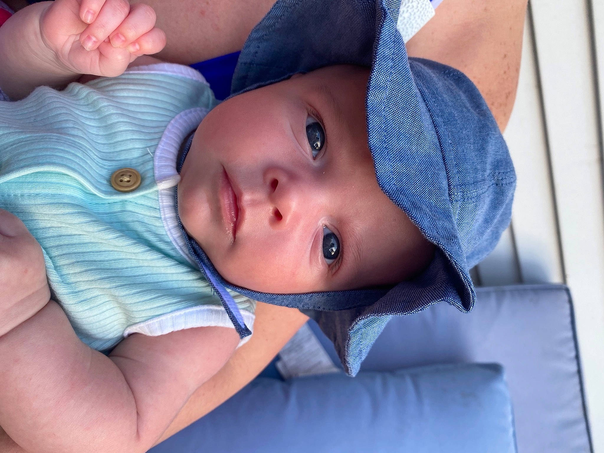Riley is registered to the contest to win money with this photo: azure, baby, baby_toddler_clothing, blue, cap, cheek, comfort, eye, eyebrow, eyelash, gesture, hat, headgear, headwear, iris, lip, neck, nose, person, skin