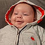 baby, hoodie, smile, face, child, infant, clothing, orange, gray, zipper, cute, happy, indoor, soft, baby_bottle, relaxed, portrait, sitting, person, closeup