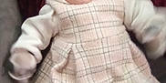 Lila joined the competition — help win amazing prizes! apparel, baby, blanket, child, cozy, cute, furniture, happy, human, indoor, infant, patterned_clothing, plaid_dress, portrait, sitting, smiling, soft_fabric, warm, white_sleeves, young_child