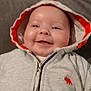 baby, hoodie, smile, face, child, clothing, infant, apparel, cute, baby_clothes, portrait, happy, young_child, indoor, people, person, warm_clothing, zipped_jacket, infancy, headwear
