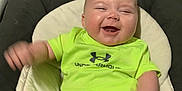 Lucas is registered to the contest to win money with this photo: baby, infant, smiling, laughing, child, clothing, under_armour, seat, cushion, indoor, happy, cute, motion_blur, shorts, sock, person, portrait, neon, bright, young