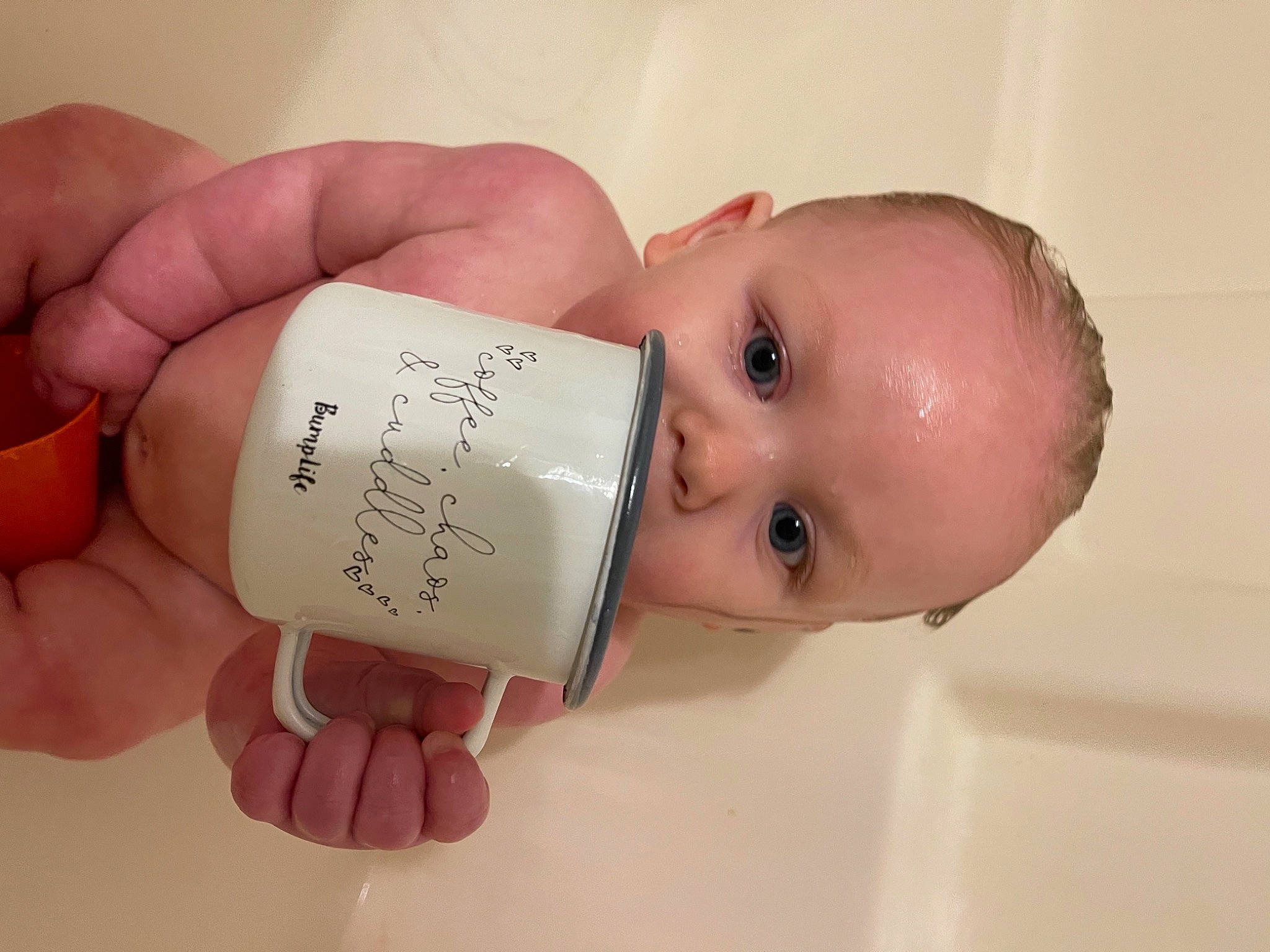 Kennedy is registered to the contest to win money with this photo: baby, baby_products, bathing, cheek, chest, drinkware, eyelash, finger, fluid, hand, handwriting, happy, lip, nail, nose, person, room, skin, thumb, toddler
