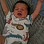 baby, infant, onesie, animal_print, blanket, stretching, arms_up, sleepy, cozy, soft_texture, cute, newborn, person, child, indoors, resting, expression, face, head, clothing