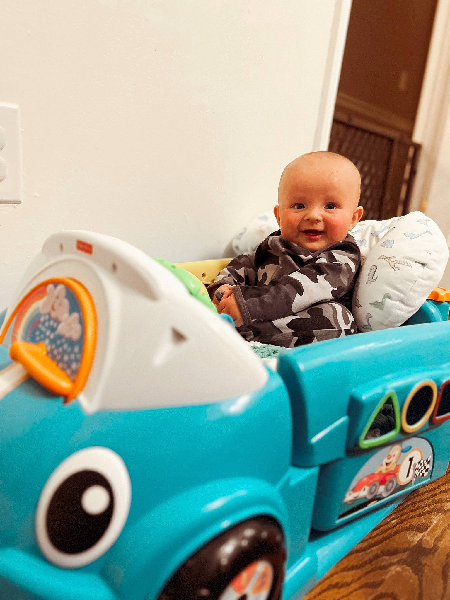 Laine Wilder is registered to the contest to win money with this photo: automotive_design, automotive_exterior, automotive_tire, baby, baby_playing_with_toys, baby_toddler_clothing, child, electric_blue, fun, green, happy, motor_vehicle, person, personal_protective_equipment, play, riding_toy, tire, toddler, toy, vehicle