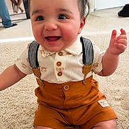 Axianno joined the competition — help win amazing prizes! baby, child, smiling, indoor, carpet, suspenders, orange_shorts, happy, cute, person, clothing, shorts, shirt, eyes, face, young, infant, sitting, home, joyful