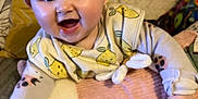 Daisy-Mae joined the competition — help win amazing prizes! baby, smiling, infant, cushion, blanket, pillow, lemon_pattern, clothing, happy, face, cute, indoors, child, soft_fabric, person, toddler, cozy, home, comfort, playful