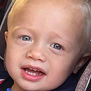 Brody joined the competition — help win amazing prizes! baby, blonde_hair, blue_eyes, car, car_seat, casual_clothing, child, cute, expression, face, hoodie, interior, person, portrait, safety, seat, seatbelt, smile, toddler, young_child