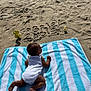 Gabriel participe au concours pour gagner de l'argent avec cette photo : baby, beach, sand, towel, striped_towel, milestone, number_2, balloon, text_in_sand, infant, white_onesie, sunlight, shadow, outdoor, summer, child, crawling, celebration, cute, skin