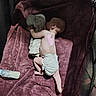 Matteo is registered to the contest to win money with this photo: baby, diaper, blanket, stuffed_animal, milk_bottle, playpen, sleeping, infant, soft_toy, nap, child, indoors, light, shadow, resting, toddler, cute, peaceful, skin, flooring