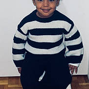 Sarah a rejoint le concours — aidez-le/la à gagner de superbes lots ! black_pants, casual, chair, child, cozy, cute, fashion, hair_buns, happy, indoor, minimalist, parquet_floor, person, portrait, sitting, smiling, striped_sweater, studio, warm, young