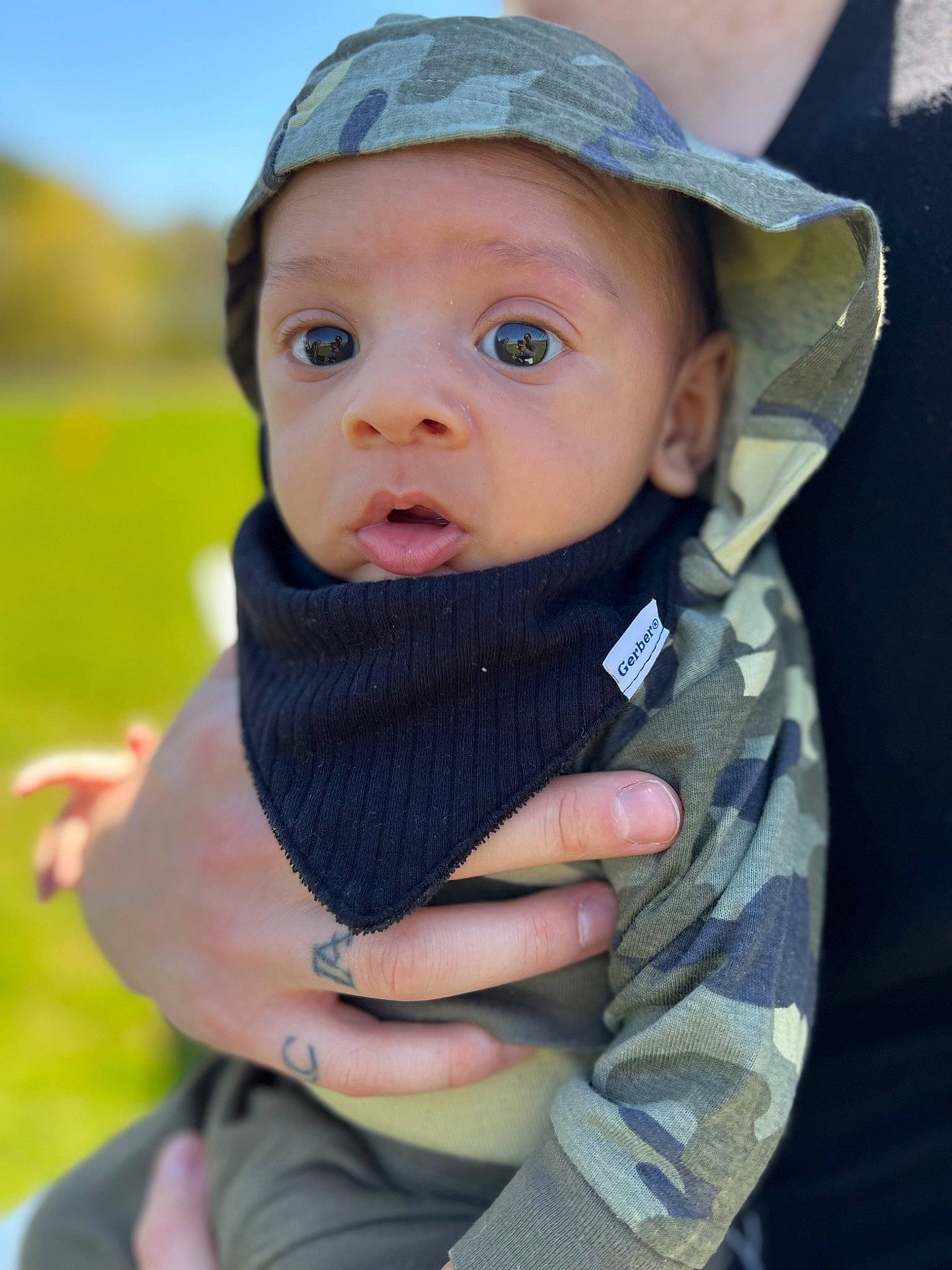 Cassius joined the competition — help win amazing prizes! baby, baby_toddler_clothing, cap, cheek, child, eye, gesture, grass, happy, hat, headwear, human_body, iris, lip, nose, people_in_nature, person, skin, sky, sleeve