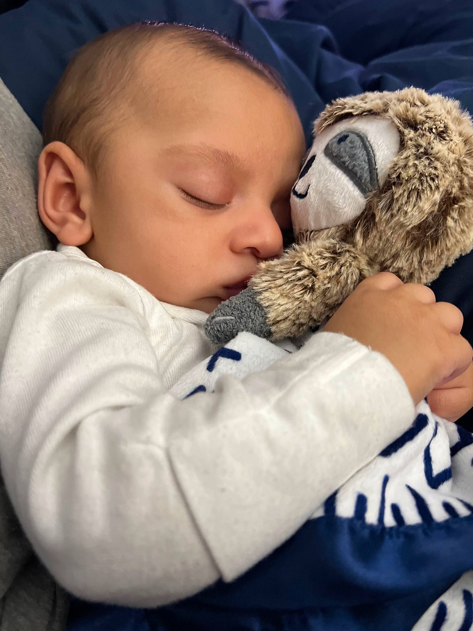 Cassius is registered to the contest to win money with this photo: baby, baby_products, baby_sleeping, baby_toddler_clothing, child, close_up, comfort, finger, fur, gesture, happy, head, hug, linens, nap, nose, person, skin, stuffed_toy, toddler