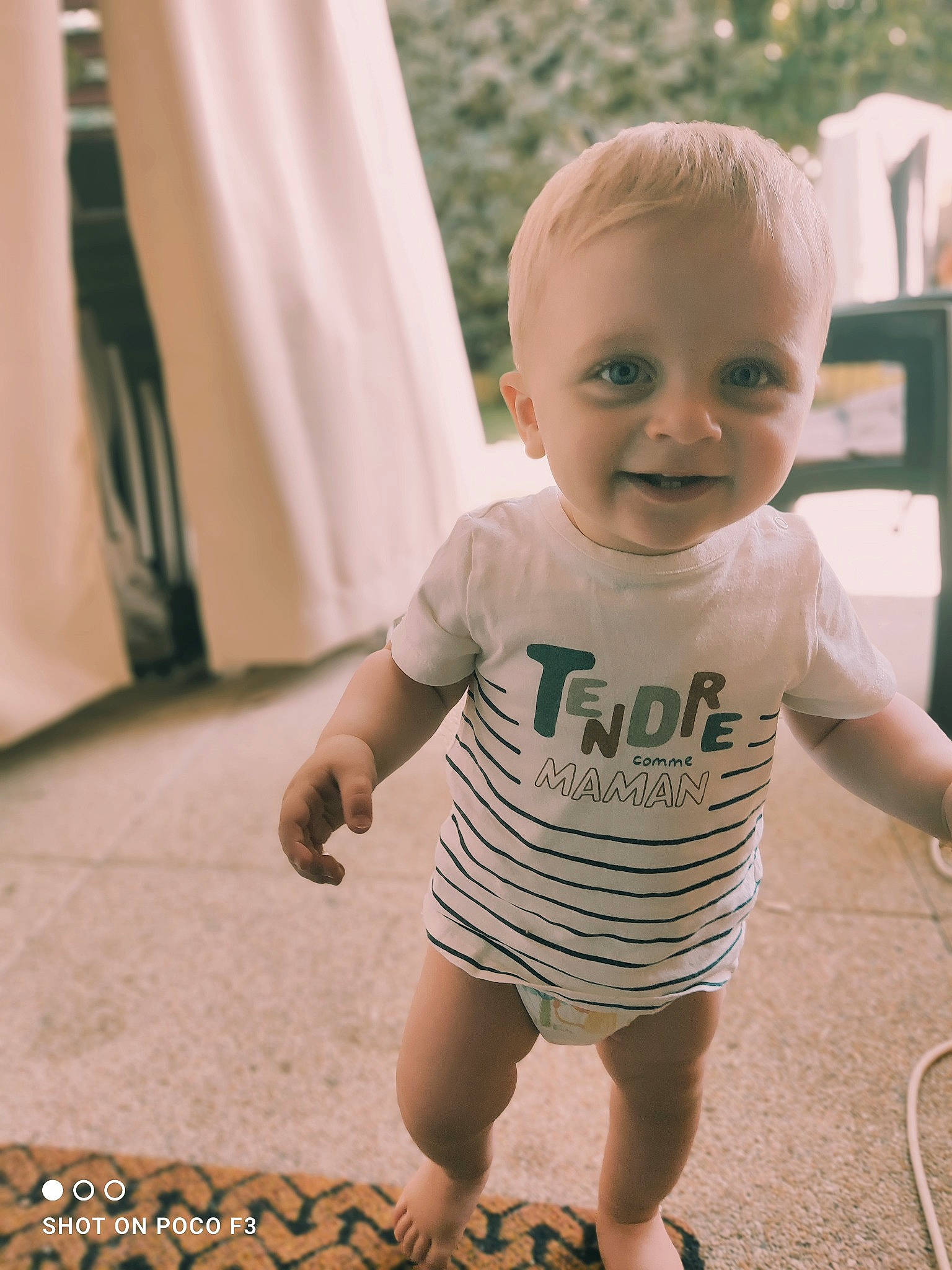 Lenny participe au concours pour gagner de l'argent avec cette photo : baby, baby_toddler_clothing, cheek, child, floor, flooring, fun, grass, happy, human_leg, joint, joy, pattern, person, play, sitting, skin, sleeve, smile, t_shirt