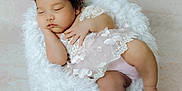 Meghan joined the competition — help win amazing prizes! baby, sleeping, floral_crown, lace, white_cushion, pastel_background, peaceful, infant, cute, soft_texture, portrait, child, adorable, resting, newborn, peace, soft_lighting, delicate, cozy, calm