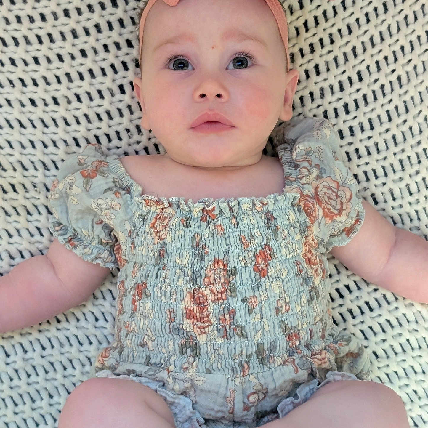 Kivera joined the competition — help win amazing prizes! baby, barefoot, blanket, child, curious_expression, cute, floral_pattern, headband, indoors, infant, lying_down, person, pink_bow, portrait, romper, skin, soft_lighting, texture, wide_eyes, young