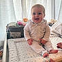 baby, infant, pajamas, smiling, changing_pad, nursery, teddy_bear, diapers, baby_wipes, curtains, hands, striped_clothing, star_pattern, furniture, indoor, child, cute, happy, person, infant_care