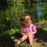 child, curious, daylight, environment, grass, greenery, nature, outdoor, peaceful, pink_clothing, pond, portrait, sandals, shadow, sitting, sunlight, toddler, trees, water, young_child