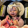 baby, child, smile, headband, car_seat, blanket, toy, pink, purple, beads, infant, clothing, safety, cute, happy, hands, face, seatbelt, plush, indoor