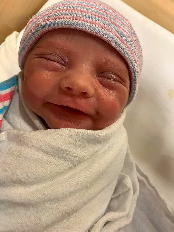 Drake is registered to the contest to win money with this photo: baby, cap, cheek, child, chin, close_up, comfort, eyebrow, face, facial_expression, forehead, happy, headwear, linens, lip, mouth, nose, person, skin, smile