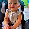 baby, child, infant, smiling, portrait, stroller, outdoor, backyard, patio, grass, fence, sunlight, sitting, bare_feet, romper, clothing, face, happy, adorable, photography
