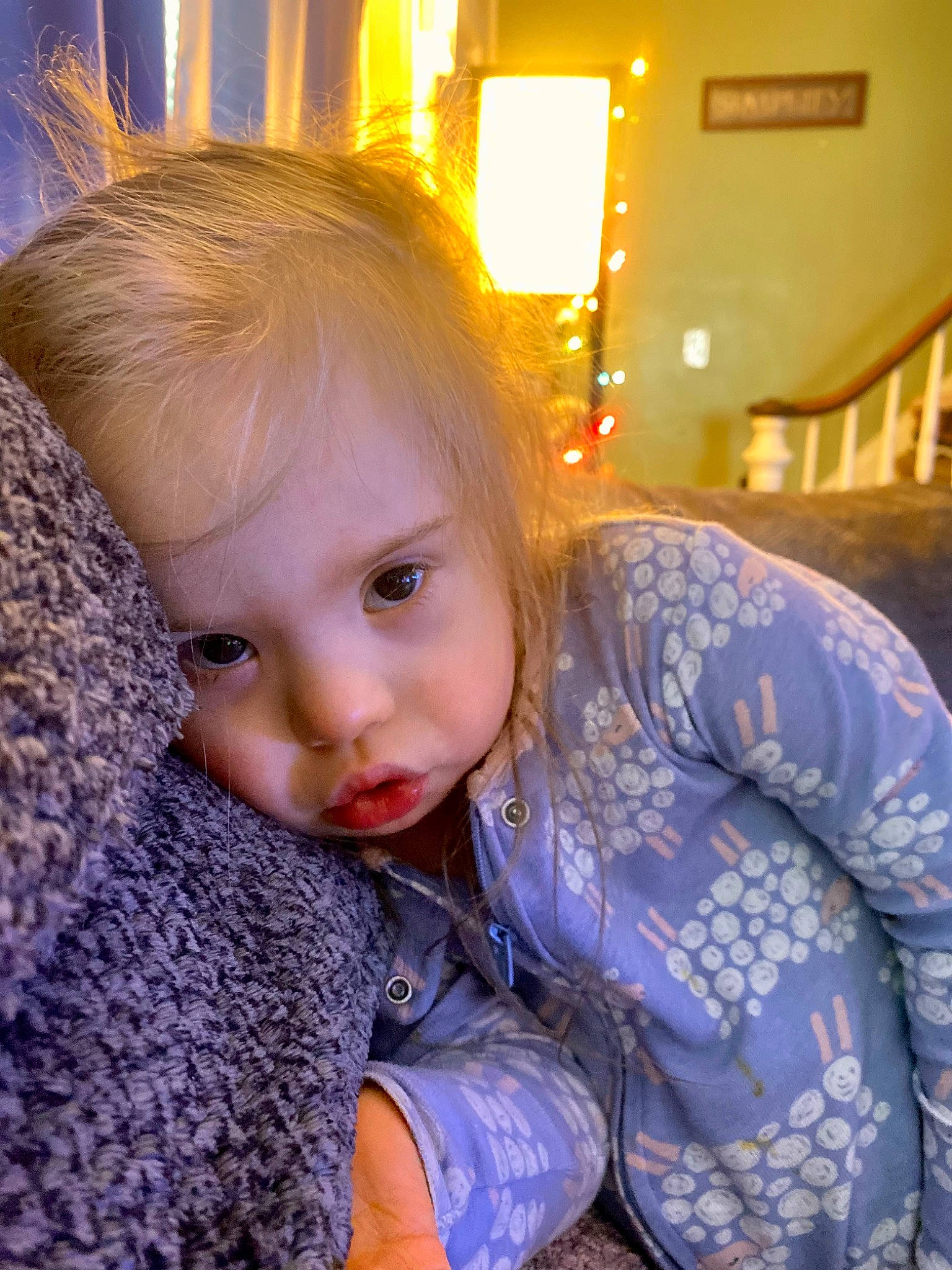 Isla is registered to the contest to win money with this photo: baby_toddler_clothing, beauty, blond, brown_hair, child, electric_blue, eye, facial_expression, fun, hairstyle, happy, human, iris, pattern, people, person, sitting, toddler, tree, winter