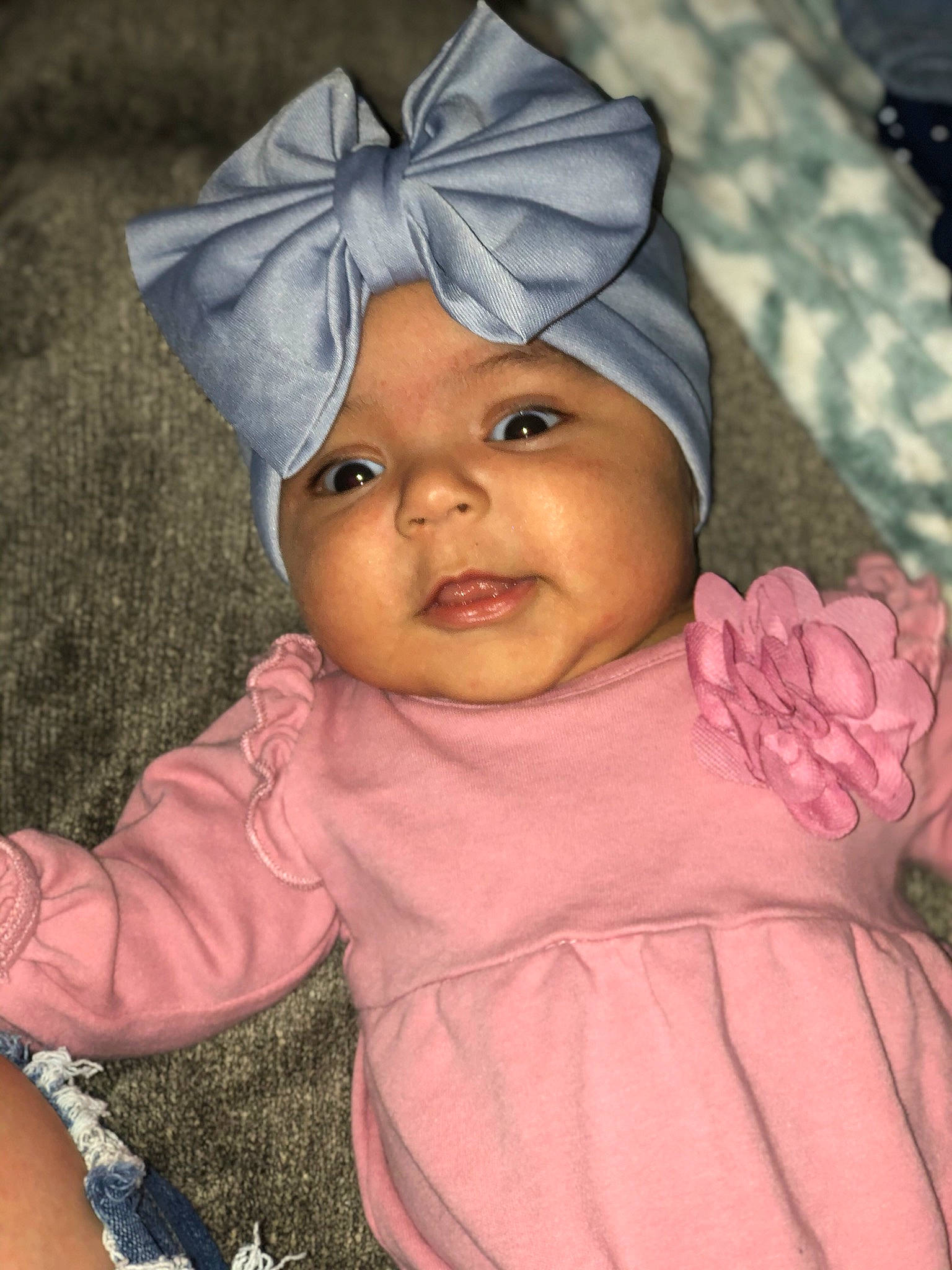 Aniyah is registered to the contest to win money with this photo: baby, bonnet, cheek, child, eye, face, forehead, head, headgear, headwear, iris, lip, person, pink, skin, smile, toddler