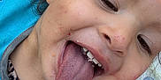 Kayleah is registered to the contest to win money with this photo: child, close_up, tongue, happy, messy, face, smile, bib, food, playful, person, young, expression, fun, outdoor, colorful, skin, hair, mouth, teeth
