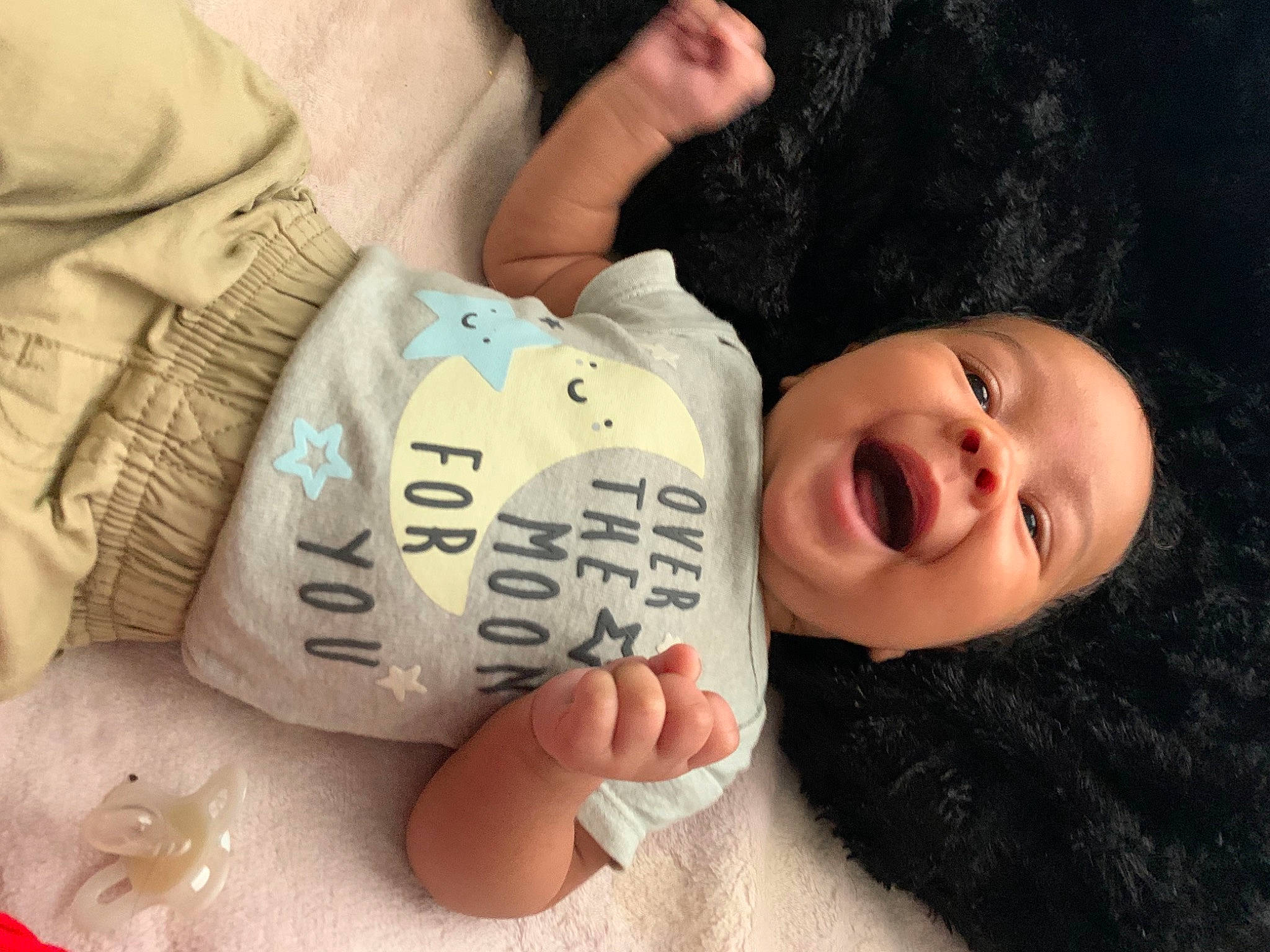 Bear is registered to the contest to win money with this photo: arm, baby, baby_toddler_clothing, cheek, child, chin, comfort, facial_expression, finger, hand, happy, mammal, mouth, nose, people, person, skin, sleeve, smile, thumb