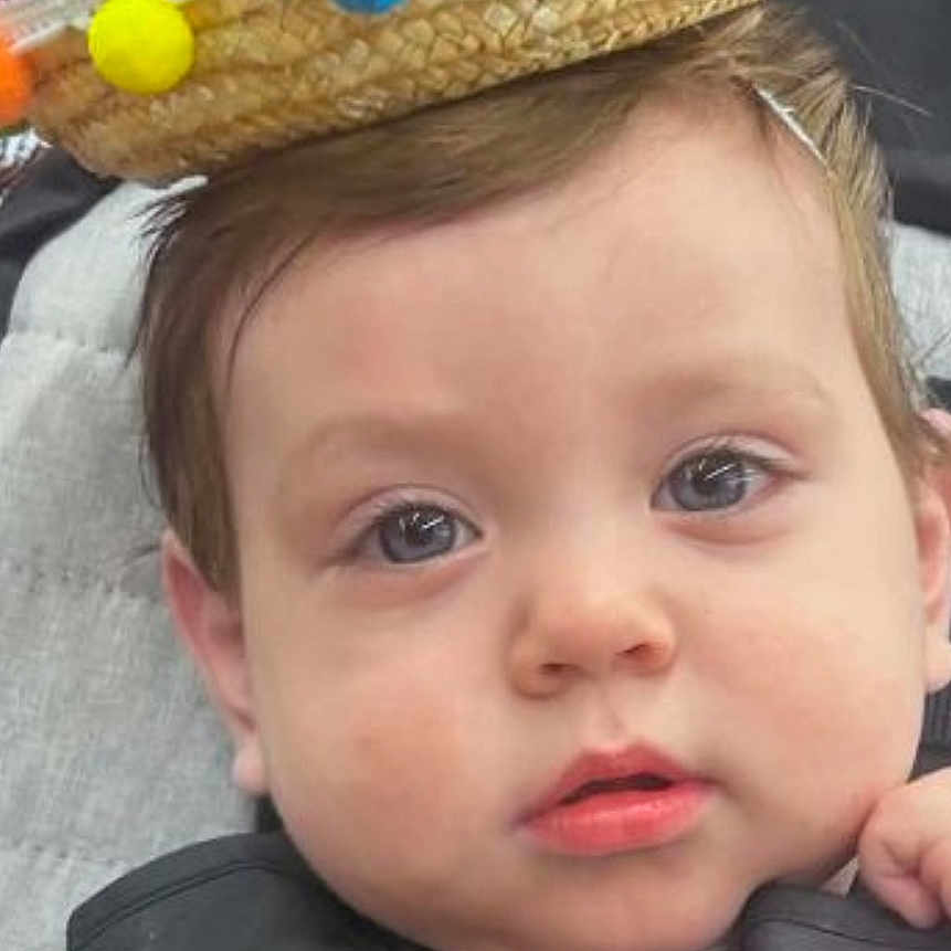 Jacob Sierra joined the competition — help win amazing prizes! baby, child, infant, portrait, face, eyes, hat, sombrero, pom_poms, colorful, car_seat, seatbelt, sitting, indoors, vehicle, travel, blue_shirt, brown_hair, looking_at_camera, close_up